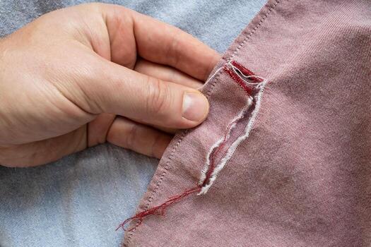 Customer photographing a torn seam on a shirt